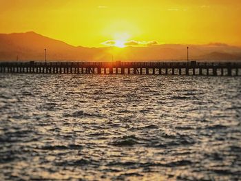 Scenic view of sea against orange sky