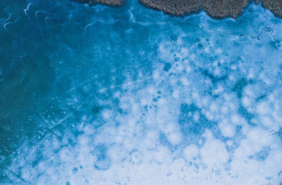 Aerial view of a frozen lake. ice sheet background. frozen waves on the lake. ice background. 