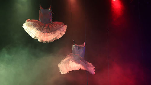 Close-up of illuminated lighting equipment hanging at night