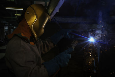 Man working in illuminated room