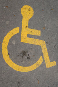 Yellow disabled sign on road
