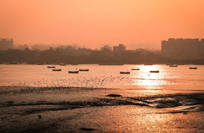 Scenic view of sea against orange sky