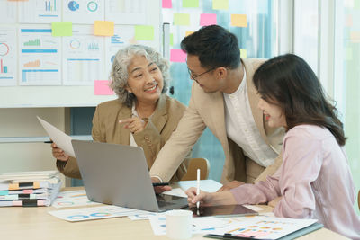 Group of asian business working together in a modern office.