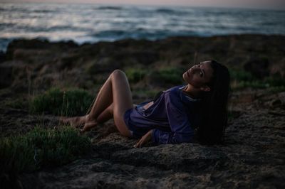 Portrait of sensuous woman relaxing at beach