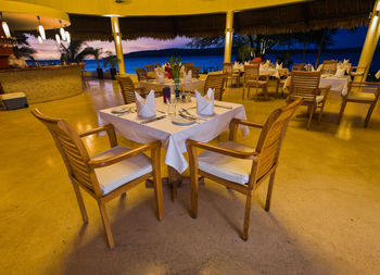 Empty chairs and tables in restaurant