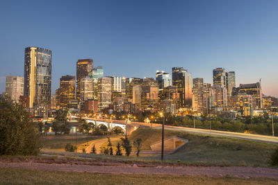 View of city buildings against clear sky