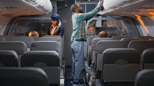 Rear view of people traveling in airplane