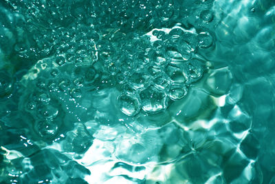 Clear green sea surface with sparkling bubbles, concept for refreshing feeling background.