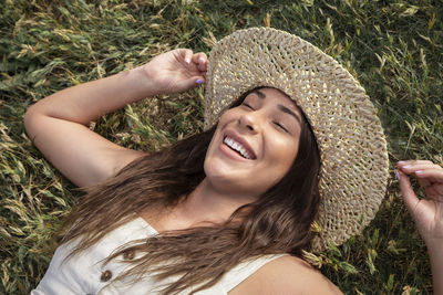 Pretty latina woman laughing in the grass