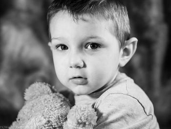 Close-up portrait of cute boy with teddy bear