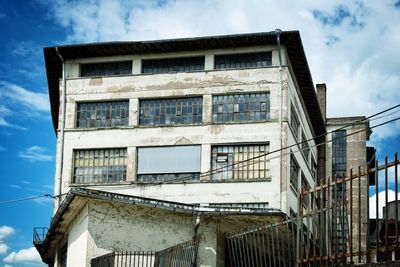 Low angle view of abandoned building against sky