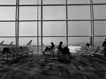 Group of people sitting on floor at airport