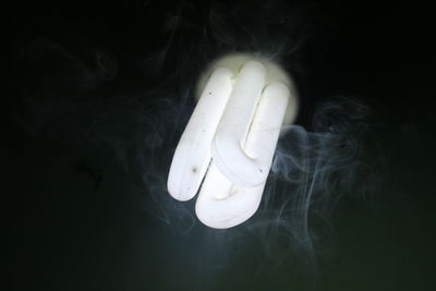 Close-up of illuminated light over black background