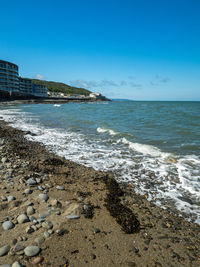 Scenic view of sea against clear blue sky