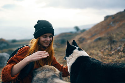 Portrait of smiling young woman with horse in winter