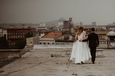 People walking on street against sky