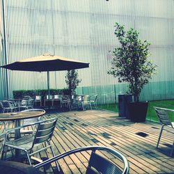 Empty chairs and table against trees