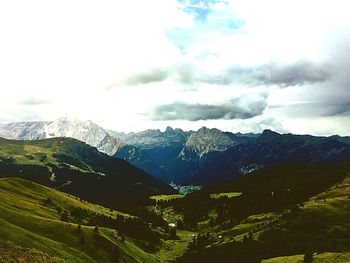 Scenic view of mountains against cloudy sky