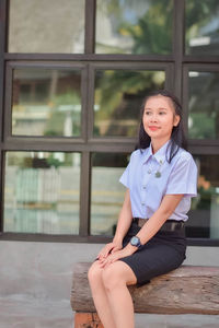 Portrait of young woman sitting on chair