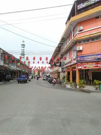 Cars on road amidst buildings in city