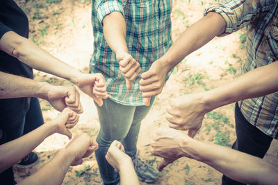 Low section of people playing with cropped hands