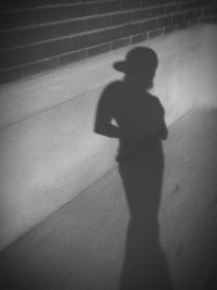 Shadow of silhouette boy standing on floor