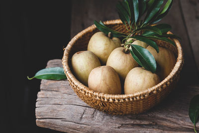 Close-up of fruits in basket on table