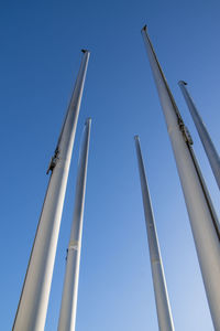 Low angle view of crane against clear blue sky