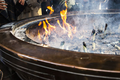 People praying by fire pit