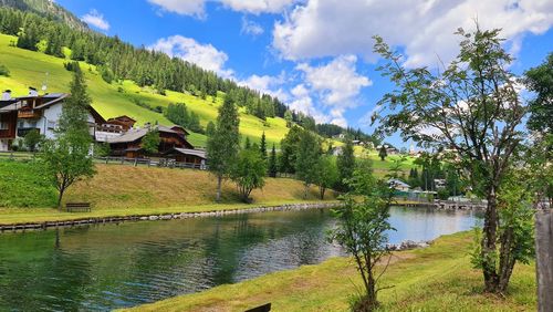 Scenic view of lake by trees against sky