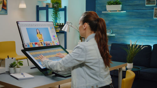 Young woman using laptop at office