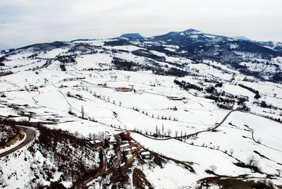 Scenic view of snow covered mountains against sky