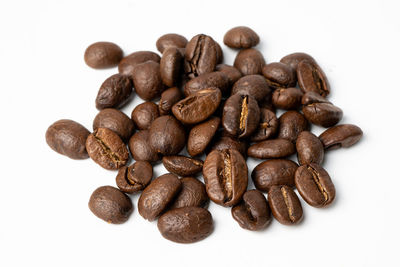 Close-up of coffee beans against white background