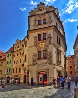 Buildings in city against blue sky