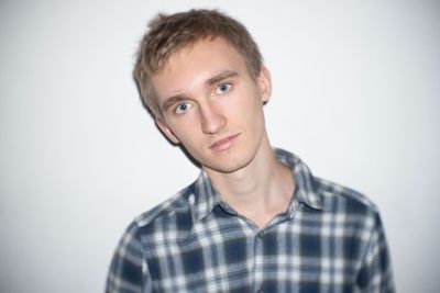 Portrait of young man against white background