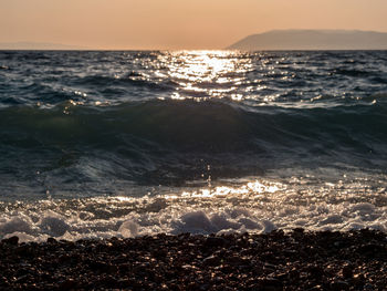 Scenic view of sea against sky at sunset