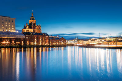 Reflection of illuminated buildings in city at night