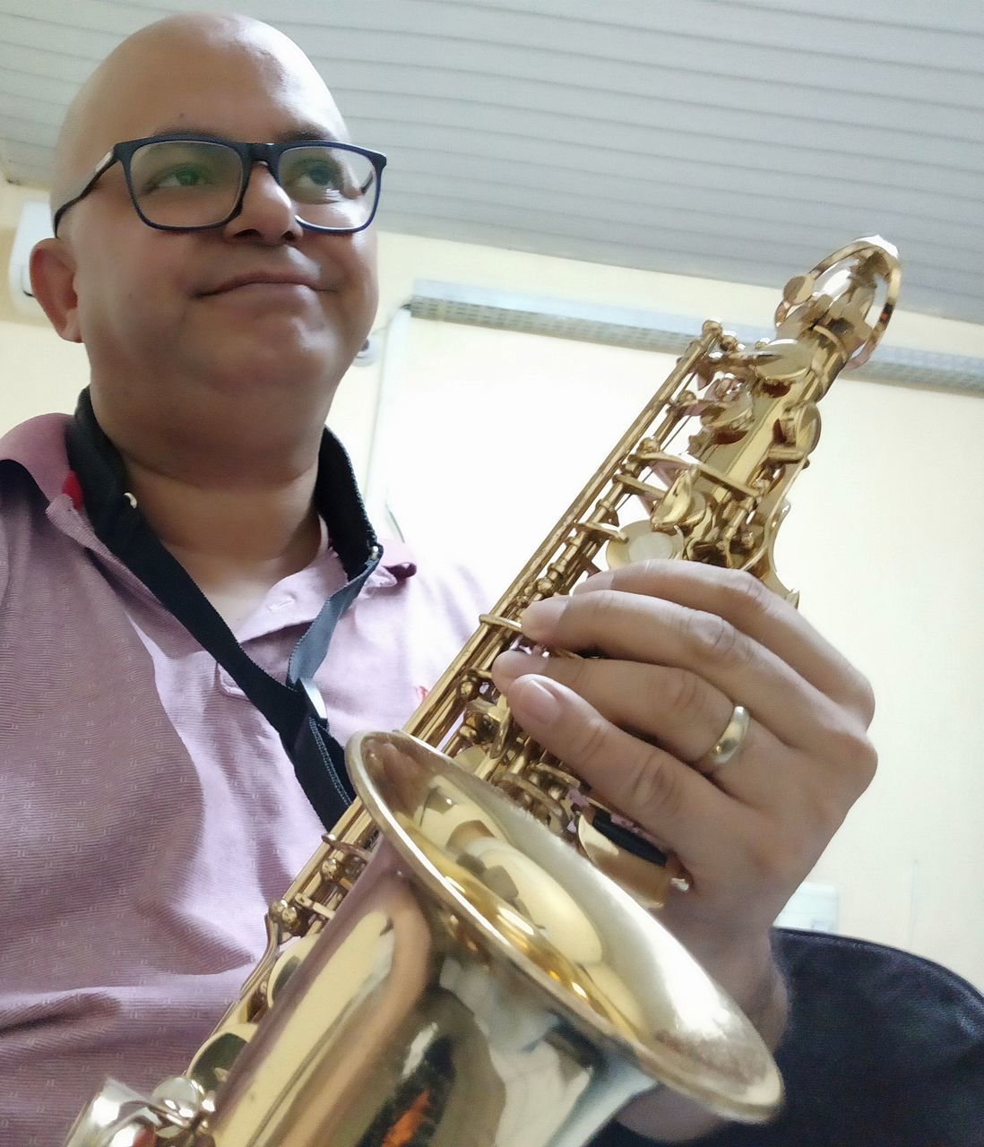 music, musical instrument, playing, arts culture and entertainment, saxophone, holding, men, real people, glasses, front view, child, one person, skill, artist, males, boys, eyeglasses, musician, leisure activity, teenager, pre-adolescent child, trumpet, teenage boys