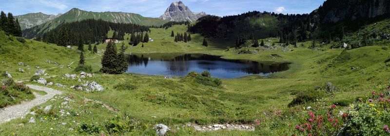 Panoramic view of lake amidst green landscape