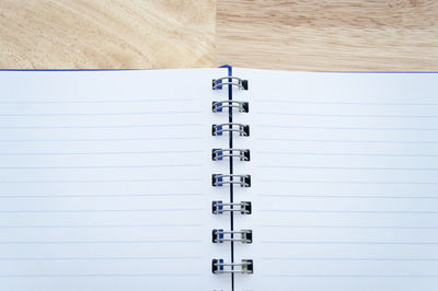 Close-up of spiral notebook on wooden table