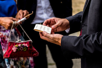 Close-up of hand holding tag