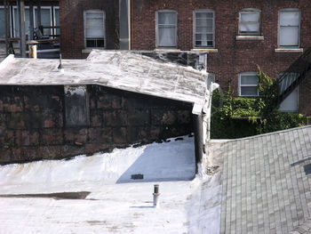 Snow covered wall by building in city