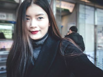 Portrait of smiling young woman in winter