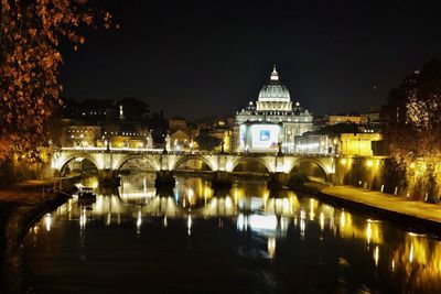 Illuminated cityscape against sky at night