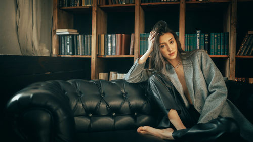 Portrait of young woman sitting in gym