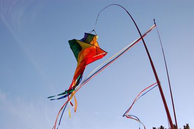 Low angle view of kites against sky