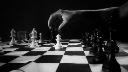 Close-up of chess pieces against black background