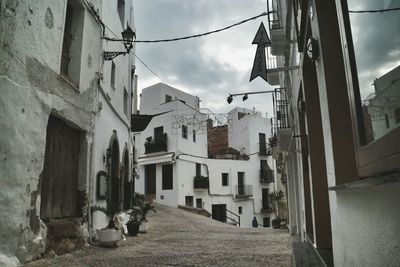 Lane amidst buildings in residential district