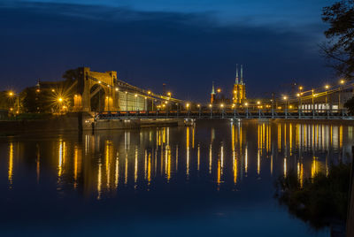 Illuminated bridge over river