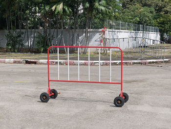 Red movable fence with wheels on the road